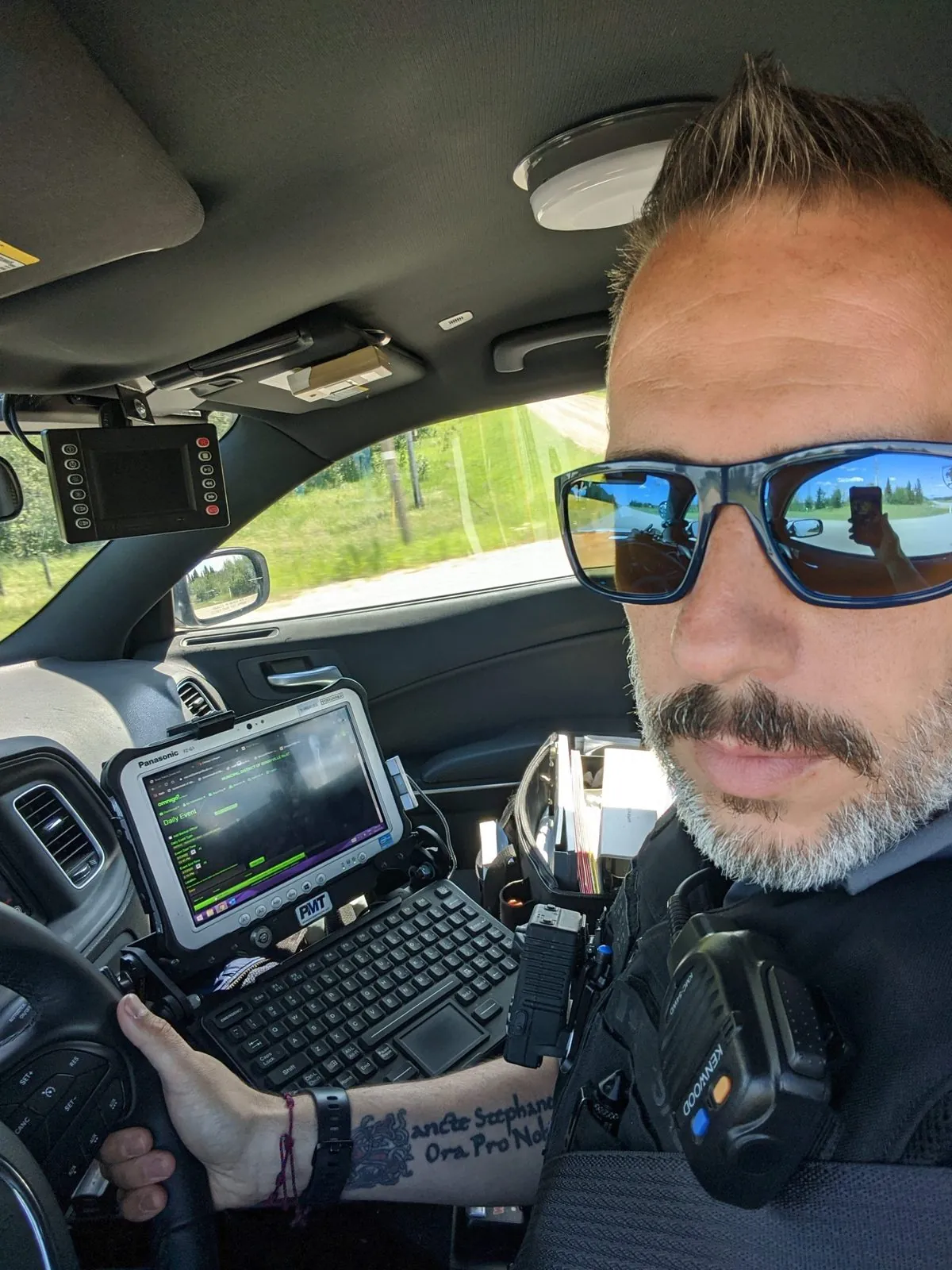 Deacon Ryan Sales on duty in a police vehicle
