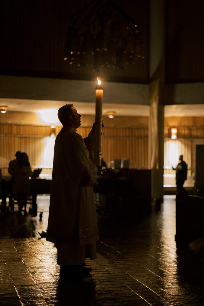 Deacon Ryan Sales holding the Paschal candle at the Easter Vigil